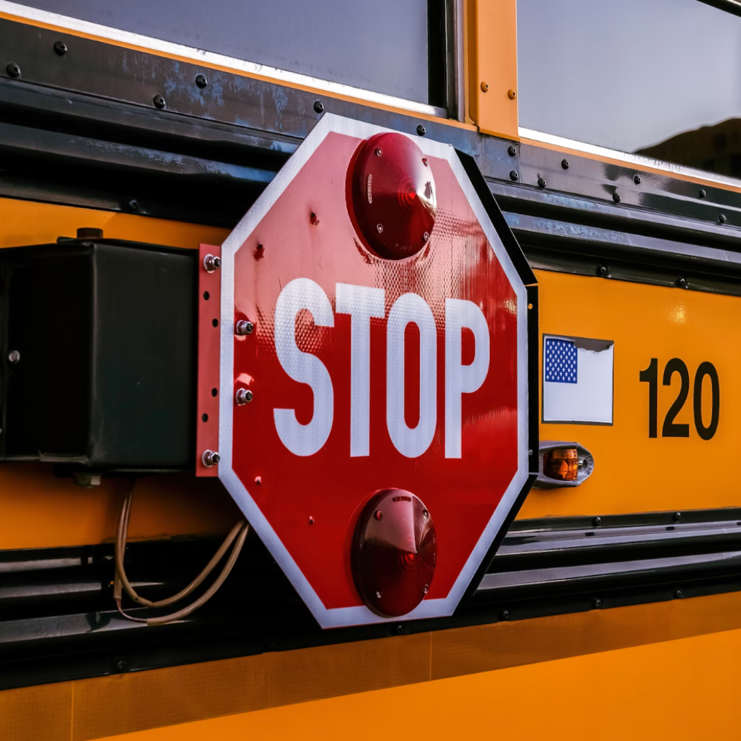 The stop sign on the side of a school bus